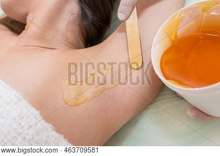 Depilation And Epilation Female Armpit With Liquid Sugar Paste By Spatula. Hand Of Cosmetologist App