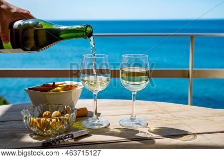 Pouring Of Txakoli Or Chacolí Slightly Sparkling Very Dry White Wine Produced In The Spanish Basque