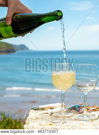 Pouring Of Txakoli Or Chacolí Slightly Sparkling Very Dry White Wine Produced In The Spanish Basque