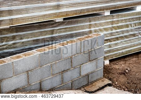 A Wall Of Hollow Concrete Blocks At A Construction Site. The Use Of Lightweight Concrete Blocks In C