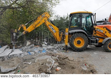 Bucharest, Romania - October 12, 2022: Details With An Excavator Demolishing A Small Building.