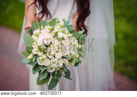 The Bride Holds A Wedding Bouquet From Roses In Her Hands, Wedding Day Flowers. Beautiful Bohemian W