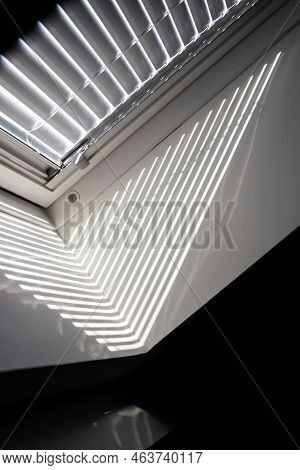 A Side Portrait Of A Velux Roof Window With A Half Open Jalousie In It To Keep The Sun And Warmth Ou