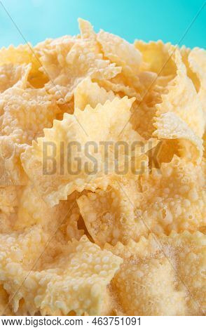 Sfrappole Or Chiachiere Or Angel Wings Background. Italian Carnival And Typical Food. Traditional Sw