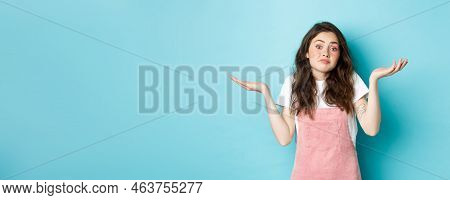 Portrait Of Confused Cute Brunette Girl Shrugging Shoulders, Know Nothing, Cant Tell, Standing Indec