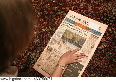 Paris, France - Sep 9 2022: Overhead View Woman Reading Financial Times Newspaper With Cover Featuri