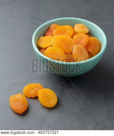 Dried Apricots On A Bowl Over Stone Background.
