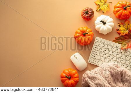 Autumn Office Workspace. Keyboard, Laptop, Notebok With Autumn Clothes And Fall Decorations - Pumpki