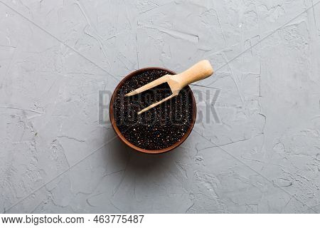 Quinoa Seeds In Bowl And Spoon On Colored Background. Healthy Kinwa In Small Bowl. Healthy Superfood