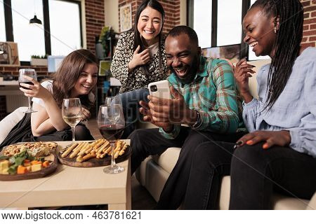 Multi Ethnic Bunch Young Adults Guffawing At African American Man Smart Phone During Friends House P