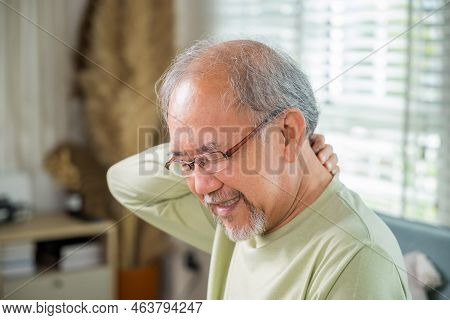 Close Up Of Sad Senior Man Neckache Hand Holding Neck, Old Man Suffering From Nape Neck Pain At Home