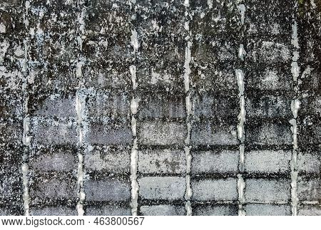 Dirty Old Eroded Cracked Plaster Cement Block Fence. Concrete Block Wall. Destroyed Crumbling Cement