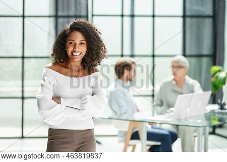 Smiling Business Woman Standing In Her Office.