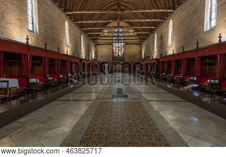 Buaune, France - July 2, 2020: Interior With Beds And Red Blankets Of Hospice And Museum L'hotel-die