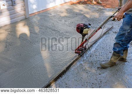An Alignment Machine Is Used To Align New Fundation Compacted Layer Of Fresh Concrete On New Drivewa