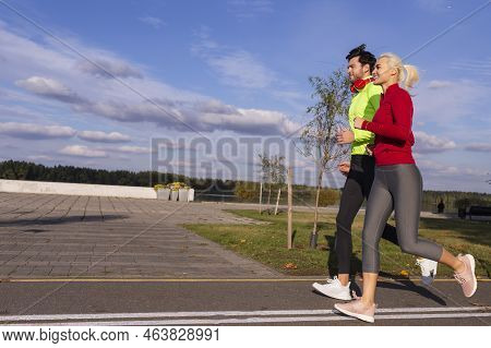 City Running Couple Happily Jogging Outside As Runners Training Outdoor Working Out While Wearing He