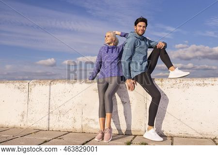 Jogging Concepts. One Positive Runners  Couple Posing Together At River Bank Outside As Runners Duri