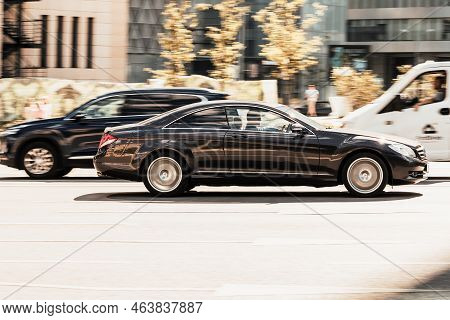 Mercedes Cl-class Rides On City Road. Side View Of Black Car On Asphalt Road In Motion. Overspeed In