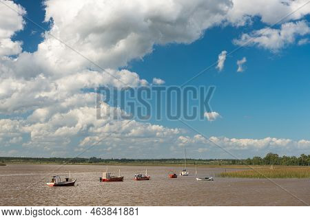 Some Fishermen Boats Anchored Near The River Coast, Under A Cloudy Sky, In Barra De Santa Lucia, Can