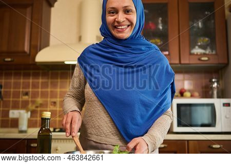 Young Muslim Arabic Pretty Woman With Head Covered In A Blue Hijab, Smiling A Beautiful Toothy Smile