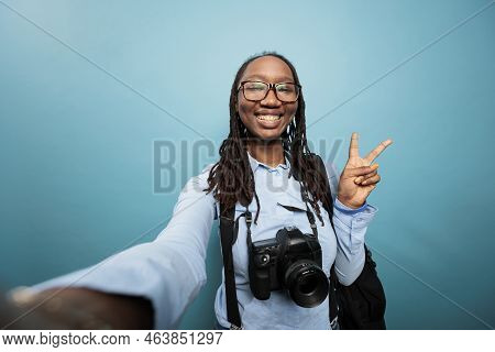 Excited Joyful Photography Entusiast Taking Selfie Photos While Standing On Blue Background. Happy S