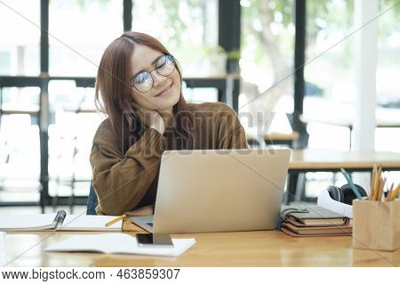 Young Asian Female Student Or Worker Learning Or Working Online Using Laptop And Giving A Confused F