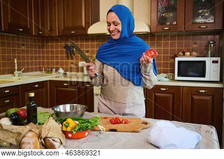 Middle-eastern Muslim Woman Housewife In Blue Hijab, Smiling A Toothy Smile, Looking At Camera, Stan