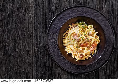 Capunti Pasta In Cream Pecorino Cheese And Pancetta Sauce In Black Bowl With , Horizontal View From 