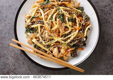 Korean Food Japchae With Meat, Egg, Vermicelli And Vegetables Closeup On The Plate On The Table. Hor
