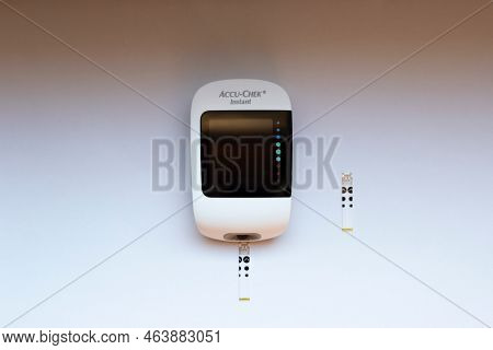 Poznan, Poland - 10.20.2022: Accu-chek Instant Glucose Meter With Test Strips Close-up