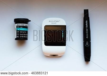 Poznan, Poland - 10.20.2022: Accu-chek Instant Glucose Meter With Test Strips And Finger Piercing De