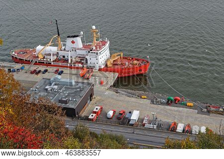 Quebec, Canada, October 8, 2022 : Red Ship At Quay On Saint-laurent River Under Promenade Des Gouver