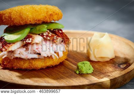 Pan-asian Cuisine Concept. Japanese Sushi Burger Made From Rice Bread, Crab Meat, Avokado And Wasabi