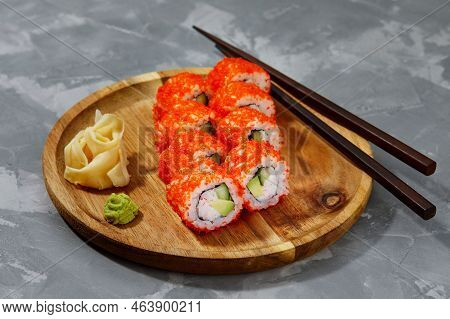 Appetizing Sushi Roll California With Avocado Shrimp Cheese And Masago Caviar On A Black Background.
