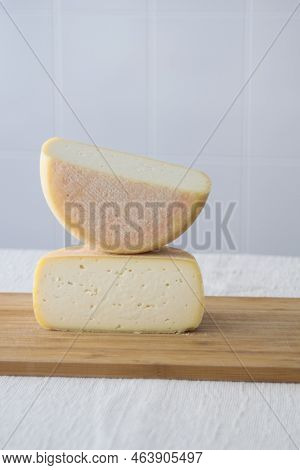 Cutted Round Partmesan Or Pecorino Cheese Head On Wooden Board On Light Background. Fresh Dairy Prod
