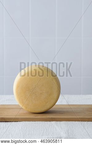 Whole Round Partmesan Or Pecorino Cheese Head On Wooden Board On Light Background. Fresh Dairy Produ