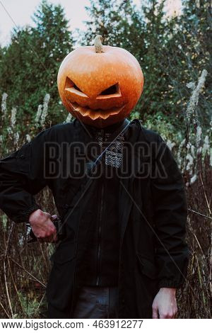 Man Portrait With An Orange Pumpkin (jack O Lantern) On His Head In A Black Jacket In The Fashion Of