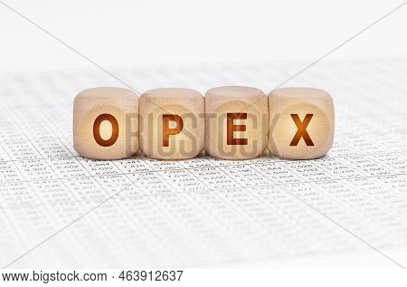 Business Concept. On The Table With Documents Are Wooden Cubes With The Inscription - Opex