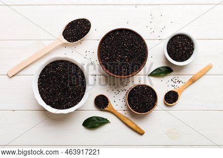 Quinoa Seeds In Bowl And Spoon On Colored Background. Healthy Kinwa In Small Bowl. Healthy Superfood
