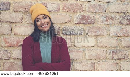 Laughing Latin American Young Adult Woman With Bobble Hat Outdoor In City In Winter