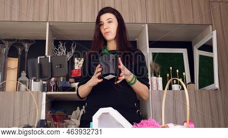 Designer Packing A Gift. Attractive Woman Decorator Conducts Online Broadcast, Conference, Records V