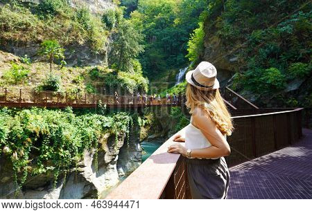 Young Woman Walking On The Path Into The Wild Enjoying Landscape With Waterfalls And The Gorges Of A