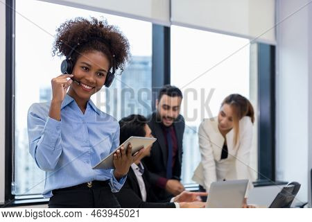 Call Center Business Woman Talking On Headset. Call Center Worker Accompanied By Her Team. Customer 