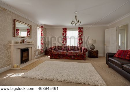 Stradishall, Suffolk, England - June 1 2017 Furnished Modern Living Room With Feature Rug And Firepl