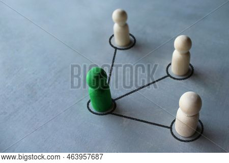Green Wooden Doll Connected With Other Wooden Dolls. Communication Social. Cooperation, Collaboratio