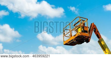 Cherry Picker With Blue Sky On Consruction Site