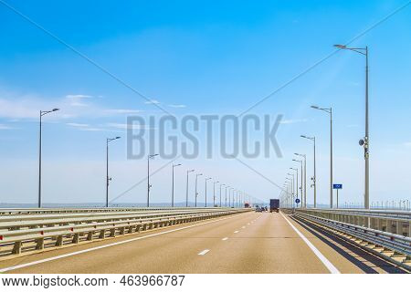 Automobile Bridge Across The Kerch Strait Or Crimean Bridge. Asphalt Road With Marking And Road Lamp