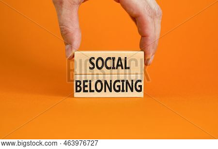 Social Belonging Symbol. Wooden Blocks With Concept Words Social Belonging On Beautiful Orange Backg