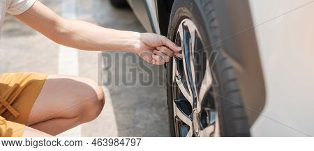 Woman Driver Hand Inflating Tires Of Vehicle, Removing Tire Valve Nitrogen Cap For Checking Air Pres
