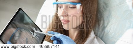 Portrait Of Patient On Consultation In Clinic, Doctor Explain Problem With Teeth, Show X Ray Scan On